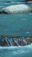 Wild river flows freely between and over stones video