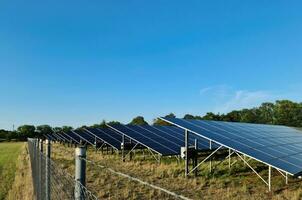 Generating clean energy with solar modules in a big park in northern Europe photo