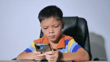 boy sitting at home playing mobile phone video