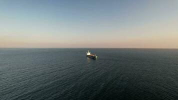 Aerial drone approaching a large marine vessel used for logistics import export, shipping or transportation video