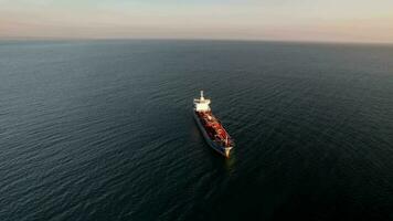 Aerial drone approaching a large marine vessel used for logistics import export, shipping or transportation video