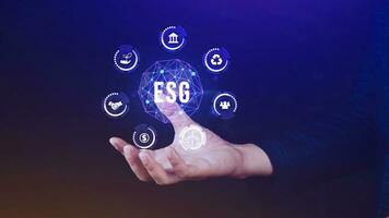 ESG icon concept in the hand for environmental, social and governance in sustainable and ethical business on the Network connection, businessman pressing button on screen. photo