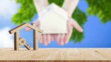 Mockup wooden house and key on wooden table, concept of real estate investment. Planning savings money of coins buy home concept for property, mortgage and real estate investment. photo