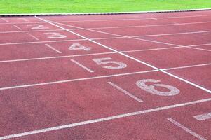 Numbers starting point on red running track,running track and green grass,Direct athletics Running track at Sport Stadium photo