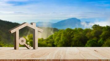 Mockup wooden house and key on wooden table, concept of real estate investment. Planning savings money of coins buy home concept for property, mortgage and real estate investment. photo