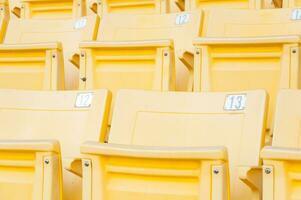 Empty yellow seats at stadium,Rows of seat on a soccer stadium,select focus photo
