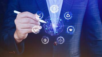 ESG icon concept in the hand for environmental, social and governance in sustainable and ethical business on the Network connection, businessman pressing button on screen. photo