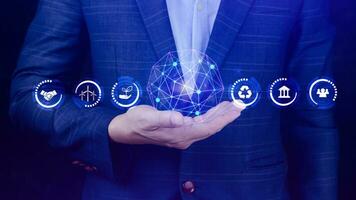 ESG icon concept in the hand for environmental, social and governance in sustainable and ethical business on the Network connection, businessman pressing button on screen. photo