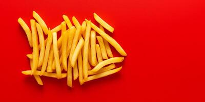 colorful minimalist crispy French fries top view isolated on red background generated ai photo