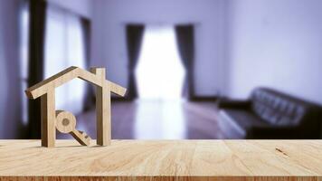 Mockup wooden house and key on wooden table, concept of real estate investment. Planning savings money of coins buy home concept for property, mortgage and real estate investment. photo