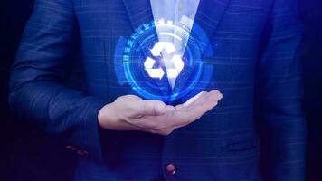 Businessman hand holding recycle icon concept in screen, for environmental, social and governance in sustainable and ethical business on the Network connection. photo