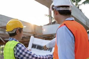 Engineers team use laptop and check the blueprint on site. Contractor and inspector inspection construction during project.civil Forman check quality assurance. Audit, inspect, quality control. photo