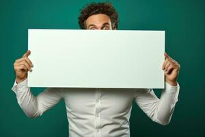 Handsome man with empty blank paper on minimalist background. photo