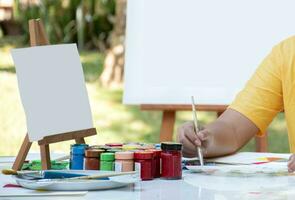Learning the art of drawing and painting outside the classroom by practicing mixing poster colors of junior high school students on the table. photo