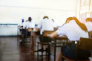 Blurred image of classroom during final test of secondary school in rural area of Thailand, concept for educational events background around the world. photo