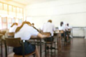 Blurred image of classroom during final test of secondary school in rural area of Thailand, concept for educational events background around the world. photo