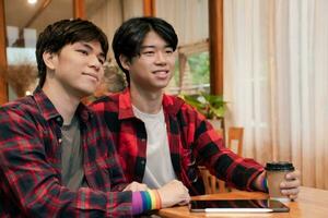 asian young adult couple spending their free times by talking and consulting their daily life problems in coffee shop, happy life, gender diversity and teenagers lifestyle concept. photo