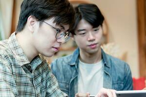 asian young adult couple spending their free times by talking and consulting their daily life problems in coffee shop, happy life, gender diversity and teenagers lifestyle concept. photo