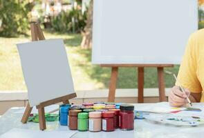 Learning the art of drawing and painting outside the classroom by practicing mixing poster colors of junior high school students on the table. photo
