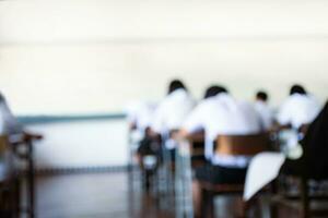 Blurred image of classroom during final test of secondary school in rural area of Thailand, concept for educational events background around the world. photo