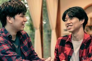 asian young adult couple spending their free times by talking and consulting their daily life problems in coffee shop, happy life, gender diversity and teenagers lifestyle concept. photo