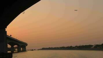 Airplane fluing over Hong Kong Zhuhai Macao bridge near Airport of Hong Kong, view from ferry boat video