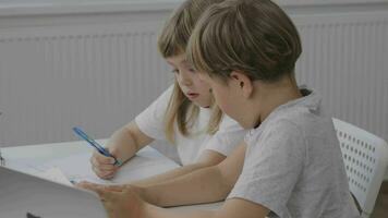 Brother helps his younger sister to make her homework video