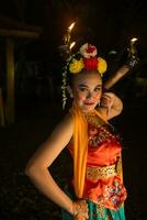 portrait of a Javanese dancer with flowers on her head and make-up on her beautiful face photo