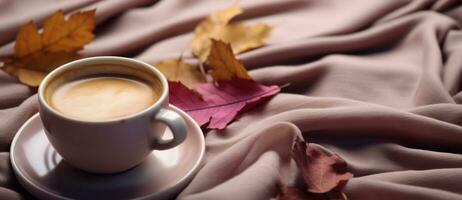 Coffee cup and autumn leaves photo