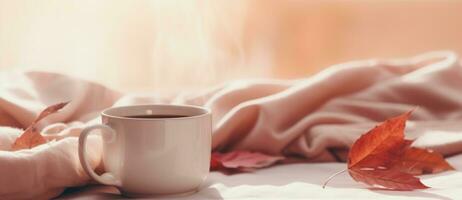 Coffee cup and autumn leaves photo