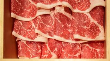 Fresh raw beef slices meat for Japanese food shabu shabu or yakiniku barbeque. Slice of high quality wagyu meat. AI Generated photo