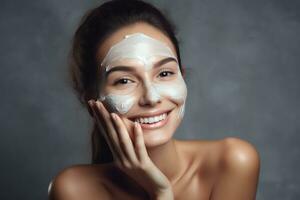 Woman smiling while applying moisturizing cream photo