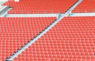 Empty orange seats at stadium,Rows walkway of seat on a soccer stadium photo