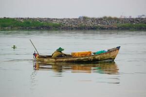 An Indonesian fisherman is fishing on a boat photo