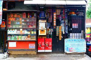 Makati, Manila, Philippines, 2023 -  Heavily locked and protected small store with many products photo