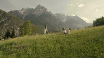 a girl and a boy is walking through the grass field video