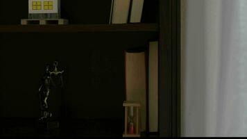 a book shelf with a statue and a book beside white transparent curtain video