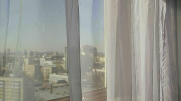 a window with white curtains and a window video