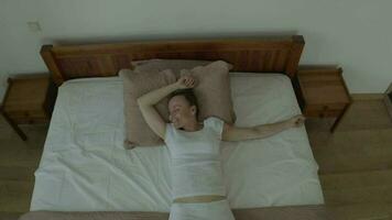 a woman in white pants is laying on a bed video