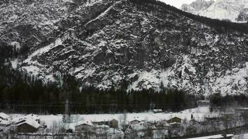 a view of a snowy mountain valley with a small town video