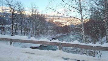 a view of a river and snow covered trees video