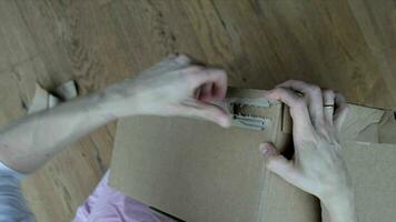 a person is opening a cardboard box video
