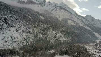 a mountain with clouds and trees on top video