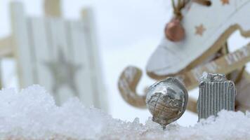 a silver snow globe and luggage sitting on top of some snow in front of skate shoes video