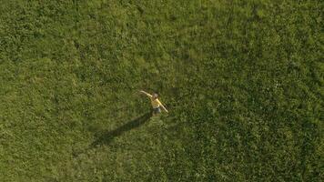 a boy is walking through a field with flowers video