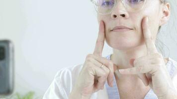 a logopedist in a white lab coat is teaching how to do speech therapy video