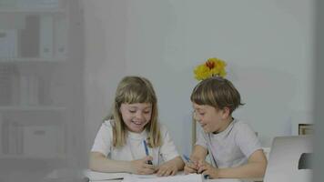 Brother helps his younger sister to make her homework video