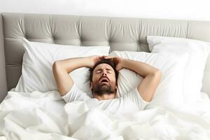 Man on bed, suffering hangover after drinking alcohol. AI generated. photo