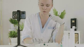 a cosmetologist is showing cosmetic product and function to the camera video