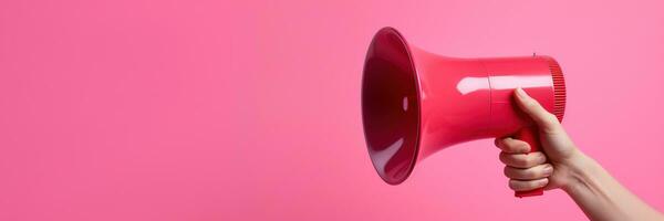 Generative AI, megaphone in hand on a empty pink background, panoramic image with copy space photo